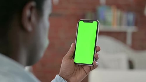 African Man Using Chroma Key Smartphone Screen