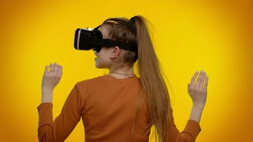 Woman Uses VR Headset Against Yellow Background