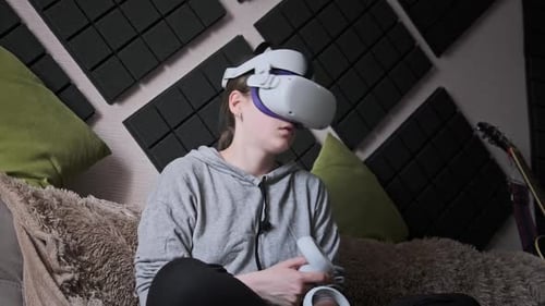 Woman Enjoys VR Gaming Sitting on Sofa