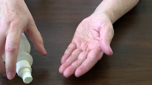 Applying Hand Sanitizer to Hands for Cleanliness