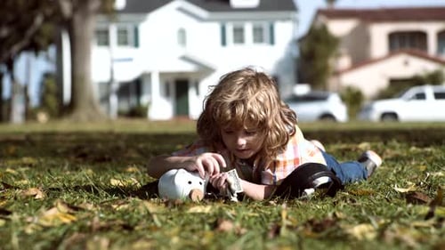 Child Saving Money in a Piggy Bank Outdoors