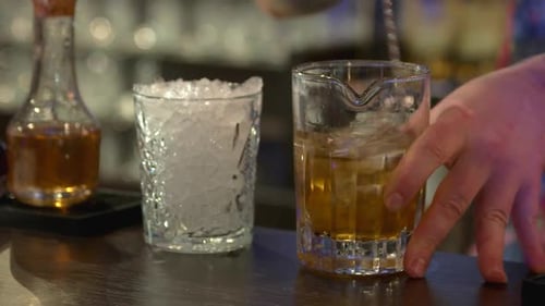 Mixing Rum with Ice in the Glass.
