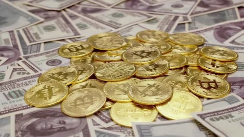 Gold Bitcoins on Stack of United States Dollars