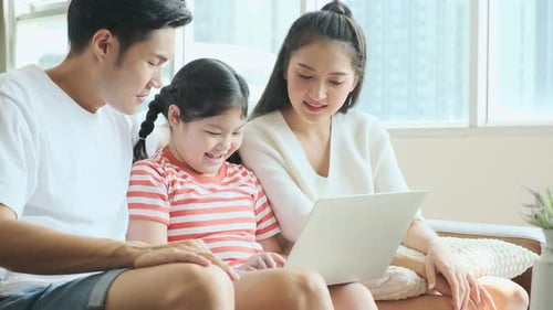 Happy Family Using Laptop at Home