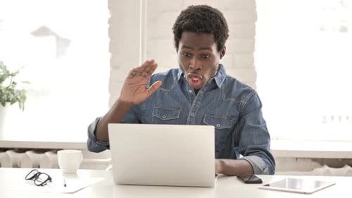 Young Adult at Laptop in Workplace