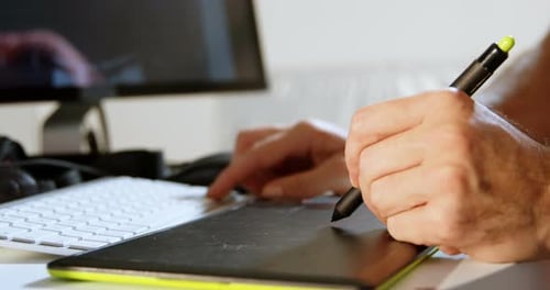 Designer using Graphic Tablet at Desk