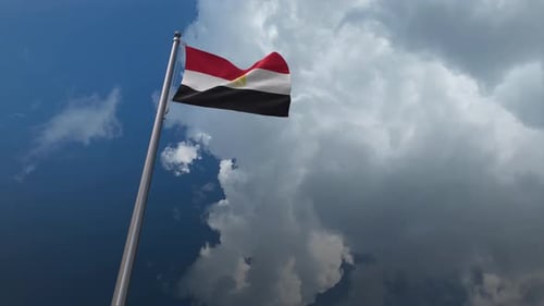 Waving Flag of Egypt Against a Cloudy Blue Sky