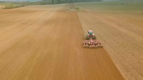 Aerial View of Tractor on Prepare a Field for Planting Top View