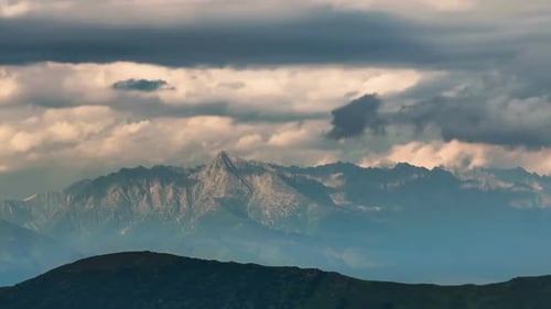 Majestic Mountain Range Under Dramatic Cloudy Sky