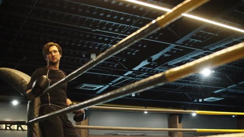 Handsome Fitness Man Having Rest in Sport Club. Boxer Standing on Boxing Ring