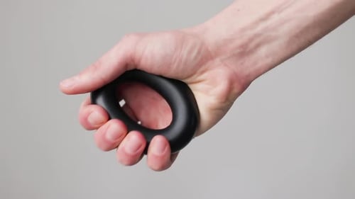 Man Works with the Black Expander By Hand on White Background