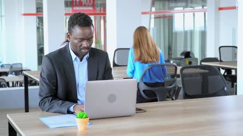African - American Employee Working in Office