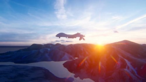 Military Drone Flying Over Mountain Landscape at Sunset