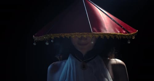 Woman with Asian Conical Hat in Dark