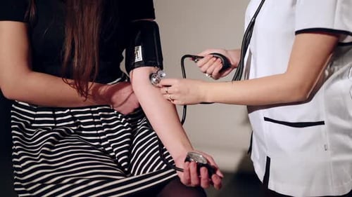 Healthcare Provider Measures Blood Pressure with Stethoscope