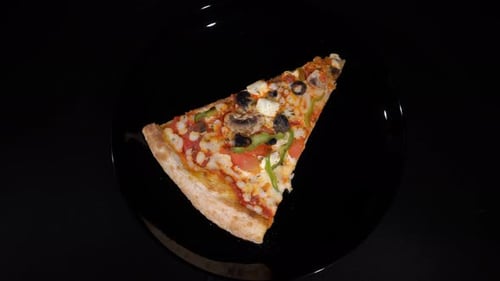 Appetizing Pizza Slice Rotating on Plate