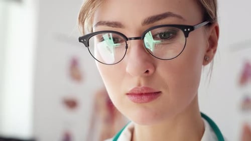 Handheld view of focused doctor over the work. Shot with RED helium camera in 8K