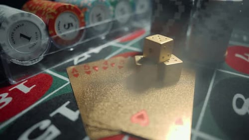 Casino Chips with Dice and Playing Cards on a Dark Table