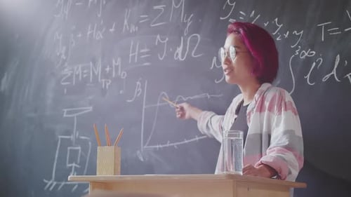 Asian Female Student Explaining Graph on Blackboard during Lesson