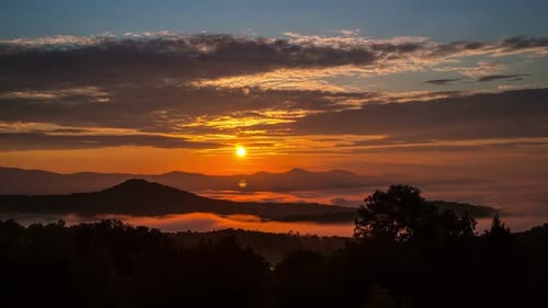 Majestic Sunrise Over the Mountains in Time Lapse