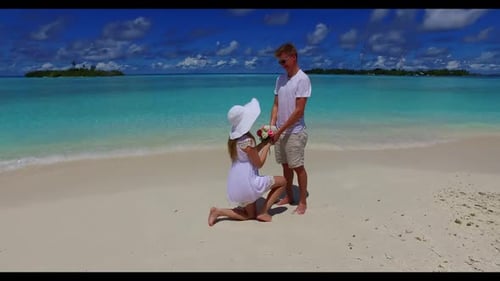 Two people suntan on luxury seashore beach time by blue ocean with white sand background of the Mald