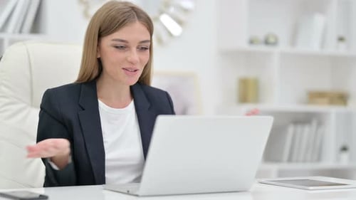 Businesswoman Doing Video Call on Laptop in Office
