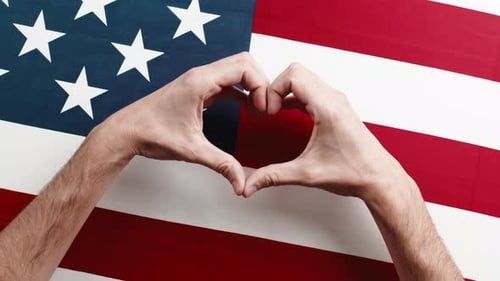 Hands Make Heart Shape Over American Flag