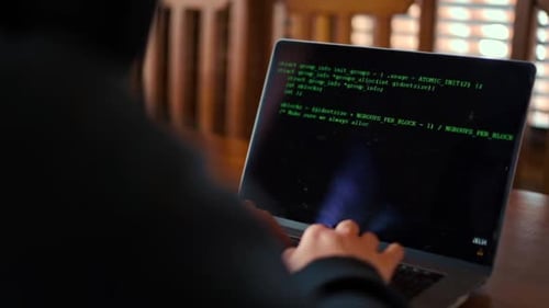 Male involved hacking into security systems. Freelancer using laptop working from home.