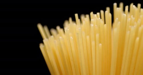 Close Up of Dry Spaghetti on Black Background