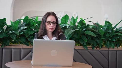 Young Professional Female Manager Using Laptop in Mall Businesswoman Working From Cafe Via Laptop