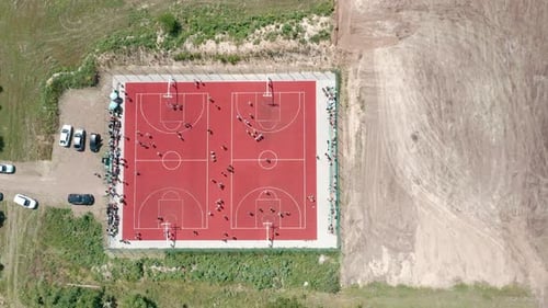 Aerial View of Young Athletes Playing Basketball on an Outdoor Public Basketball Court in Summer