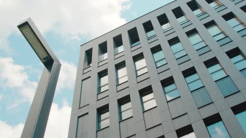 Part of the Facade of a Modern Business Center Building Is a Bottom-up View. The Sky Reflected in