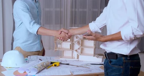 Architect And The Engineering Contractor Shaking Hands On Building Project