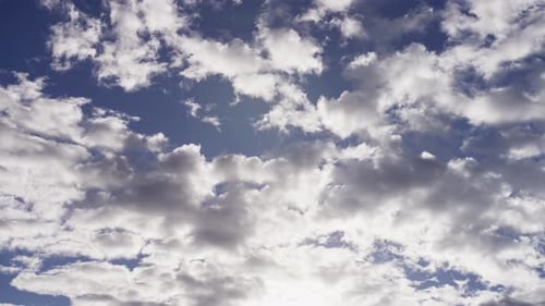 Clouds Drifting Slowly Across Blue Sky