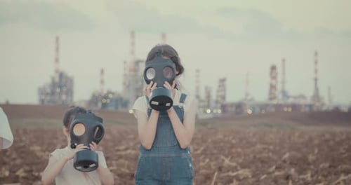 climate change crisis. Kids wearing gas masks near an oil refinery