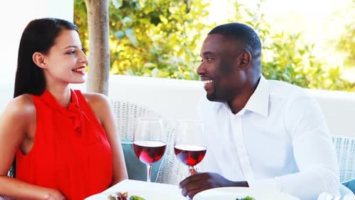 Romantic couple toasting their wine glasses