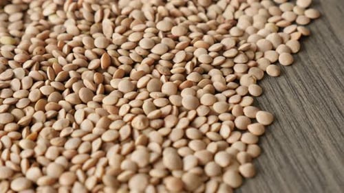 Pile of Brown Lentils on Wooden Surface