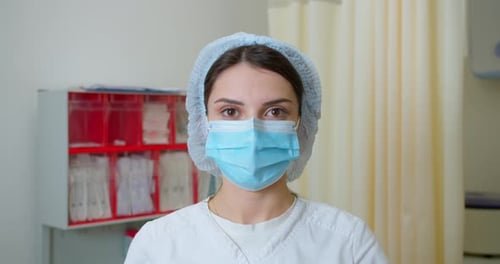 Close Up of Woman Wearing Mask and Surgical Cap