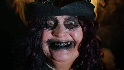 Scary person with dark makeup in the dark