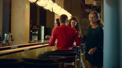 People Greeting Each Other in Bar