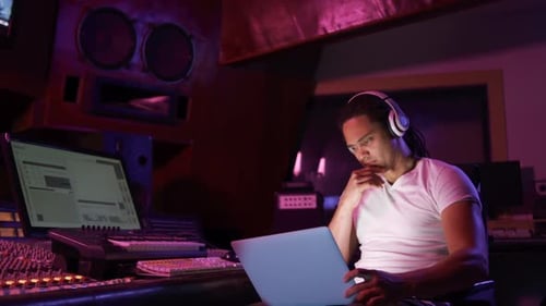 Male sound engineer using a laptop