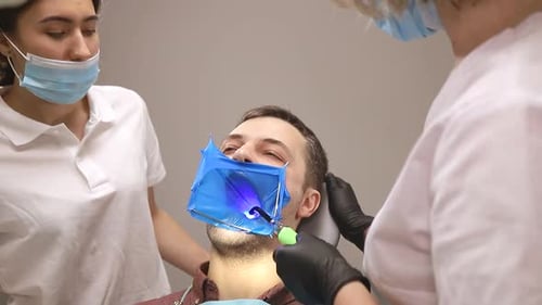 A man treats the teeth of a woman doctor, a dentist's job in the office, healthy teeth