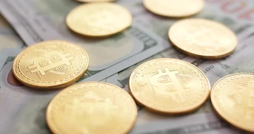 Bitcoin Coins on One Hundred Dollar Bills