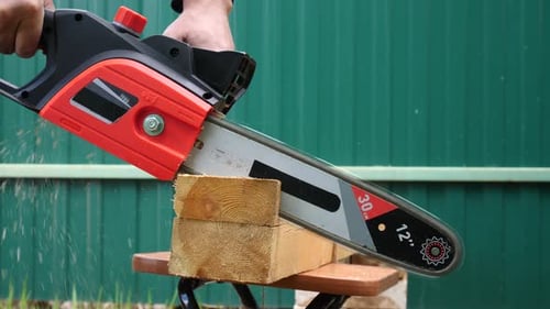 Sawing Wood With Chain Electric Saw