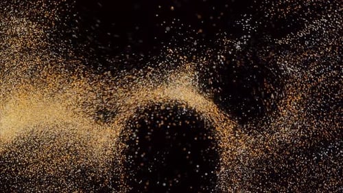 Tiny grains of colorful sand flying and forming circles