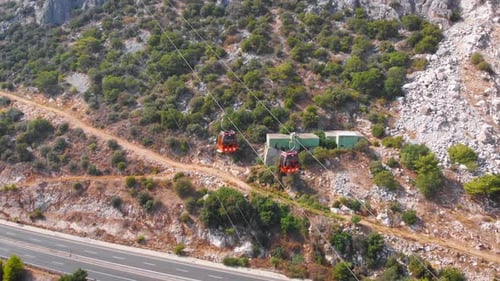 Close-up Flight Next To the Uphill Funicular with the Coast in the Background