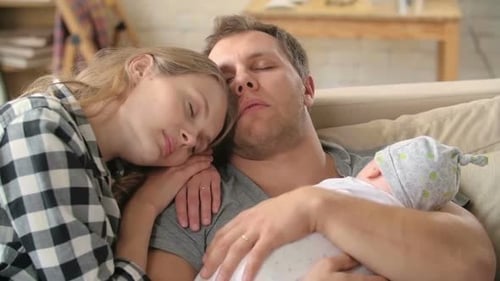 Sleeping Family with Newborn Baby at Home