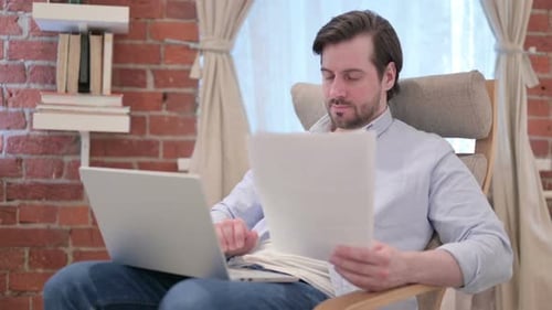 Man Working on Laptop at Home Office
