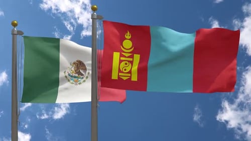 Waving Flags of Mexico and Mongolia Against Blue Sky
