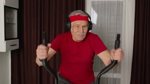 Senior Man Exercising on Elliptical at Home